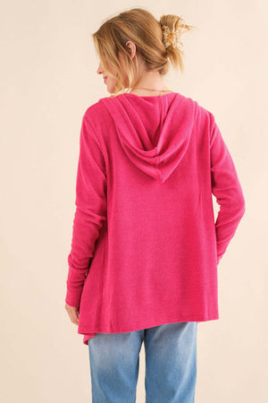 Woman wearing a pink thermal hooded open front cardigan with pockets, showcasing the back view. Ideal for cozy lounging or casual outings.