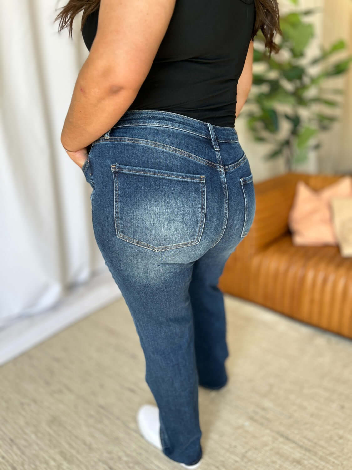 Woman wearing RFM Full Size High Rise Straight Tummy Control Jeans showcasing back view and classic straight-leg cut.