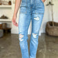 Woman wearing high-waisted distressed straight Judy Blue Jeans with patch pockets and stylish detailing for a casual-chic look.