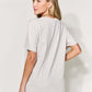 Woman wearing MAMA Round Neck Short Sleeve T-Shirt in full size, back view showing relaxed fit and soft cotton blend material