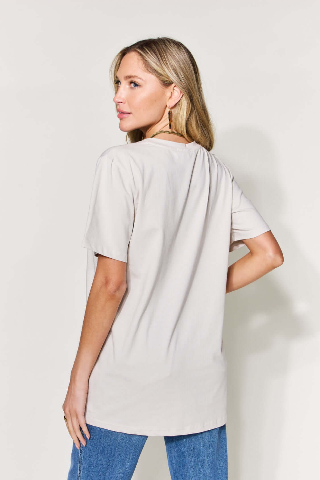 Woman wearing MAMA Round Neck Short Sleeve T-Shirt in full size, back view showing relaxed fit and soft cotton blend material