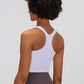 Back view of a woman wearing a white Millennia Racerback Sports Bra, showcasing its stylish design and slim fit.