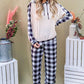 Model showcasing the And The Why drawstring hooded top and plaid pants lounge set, perfect for stylish comfort.