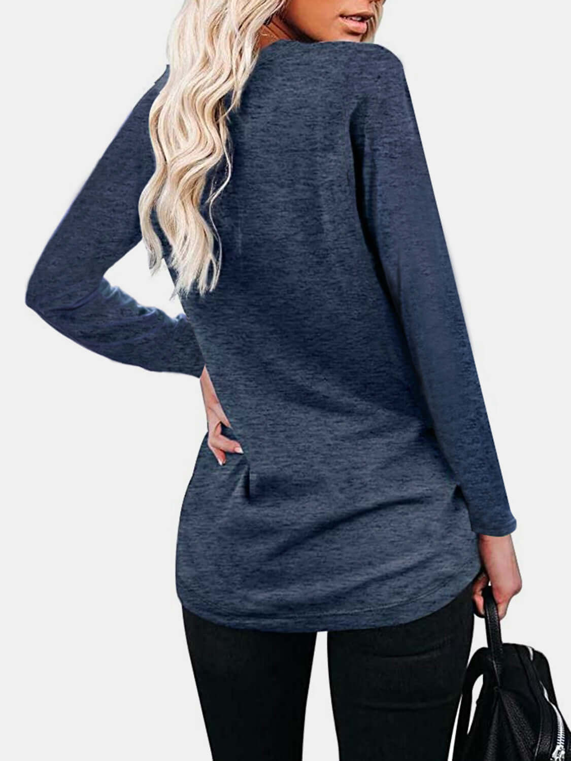 Woman wearing Bella Road round neck long sleeve t-shirt in navy blue, showing back view with pockets and slightly stretchy material.