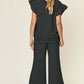 Back view of woman wearing Texture Ruffle Short Sleeve Top and Drawstring Wide Leg Pants Set in black.