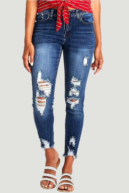 Distressed raw hem jeans with pockets and trendy design for women, perfect for a bold, edgy look.