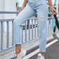 Woman wearing Bella Road Distressed Straight Jeans with Pockets, standing on a street in casual sneakers.