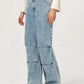 Model wearing Bella Road light wash denim wide leg jeans with pockets, showcasing trendy style and comfort.