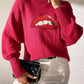 Bella Road Lip Turtleneck Sweater in pink with bold lip design, playful and stylish, perfect for unique style statements.