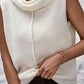 Cozy Bella Road sleeveless turtleneck sweater vest in white, featuring a central seam and stylish layered look.