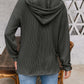 Woman wearing a dark gray drawstring dropped shoulder long sleeve hoodie, view from the back. Perfect casual wear.