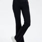 Stylish model wearing Basic Bae Pocketed Highly Stretchy Bootcut Jeans in black, showcasing comfort and versatility.