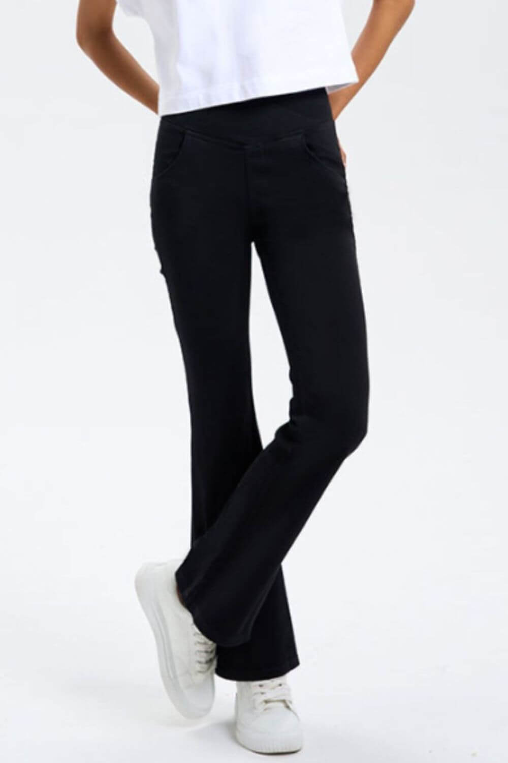 Stylish model wearing Basic Bae Pocketed Highly Stretchy Bootcut Jeans in black, showcasing comfort and versatility.