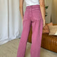 Woman wearing RFM Full Size High Rise Garment Dye Wide Leg Jeans in rich pink color, showcasing back view and relaxed silhouette.