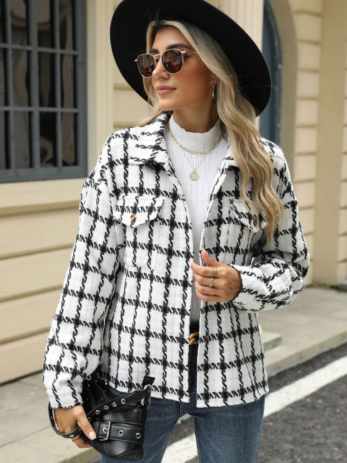 Woman wearing Bella Road Plaid Collared Neck Long Sleeve Jacket with black and white pattern, hat, sunglasses, and jeans.