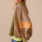 Stylish woman wearing a BiBi color block striped round neck sweatshirt in earthy tones, perfect for trendy casual outfits.