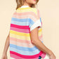 Woman wearing Striped Side Slit Short Sleeve Knit Top with colorful stripes and side slits, paired with denim shorts