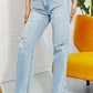 Woman wearing Allie 90's Dad Jean in light wash with distressed detailing and raw hem