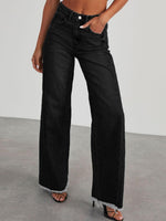 Woman wearing Bella Road Raw Hem Wide Leg Jeans with Pockets in black, showing front view of jeans with casual stretch and frayed hem.