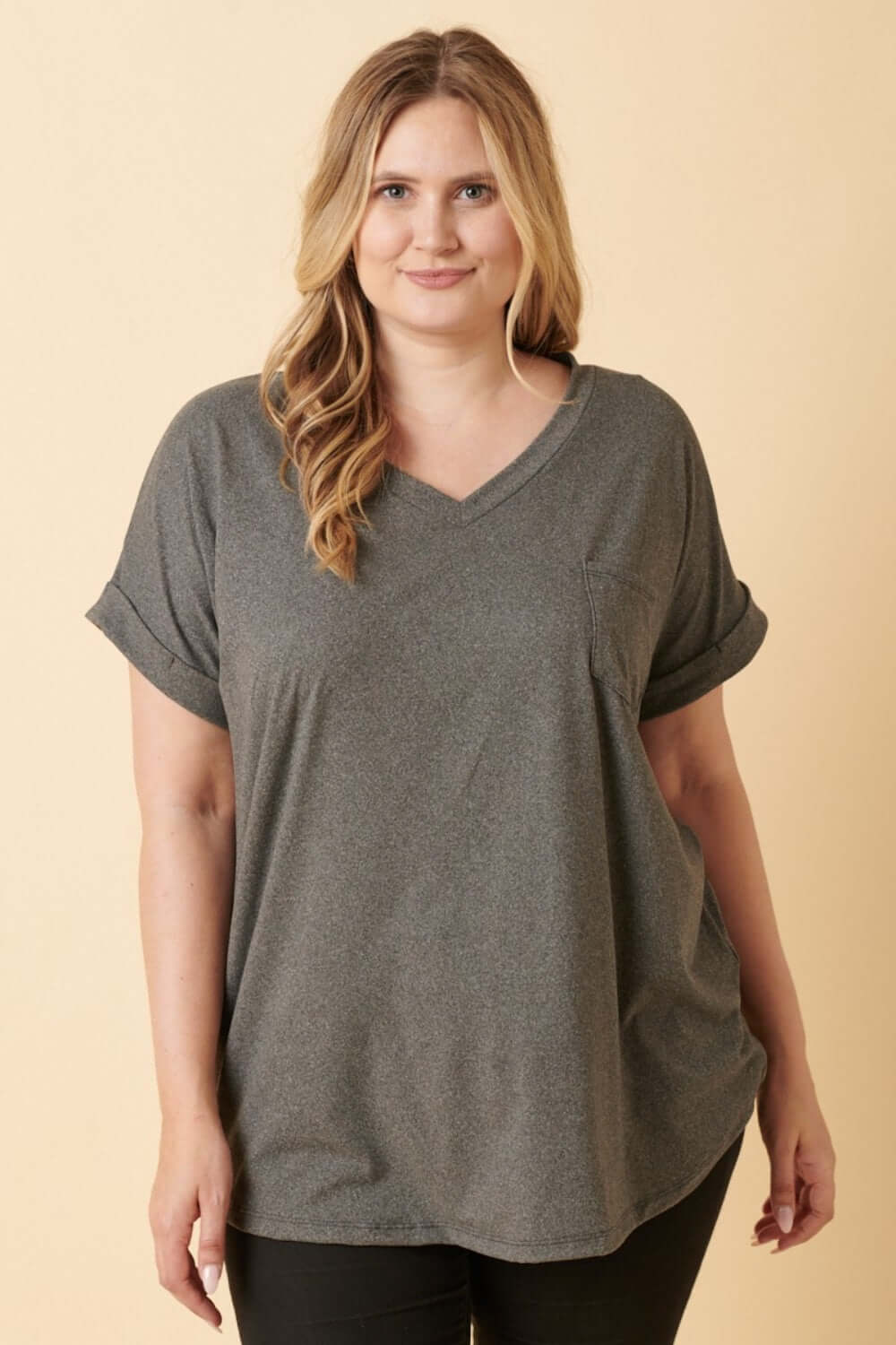 Woman wearing a gray V-Neck Rolled Short Sleeve T-Shirt, perfect for casual style and comfort.