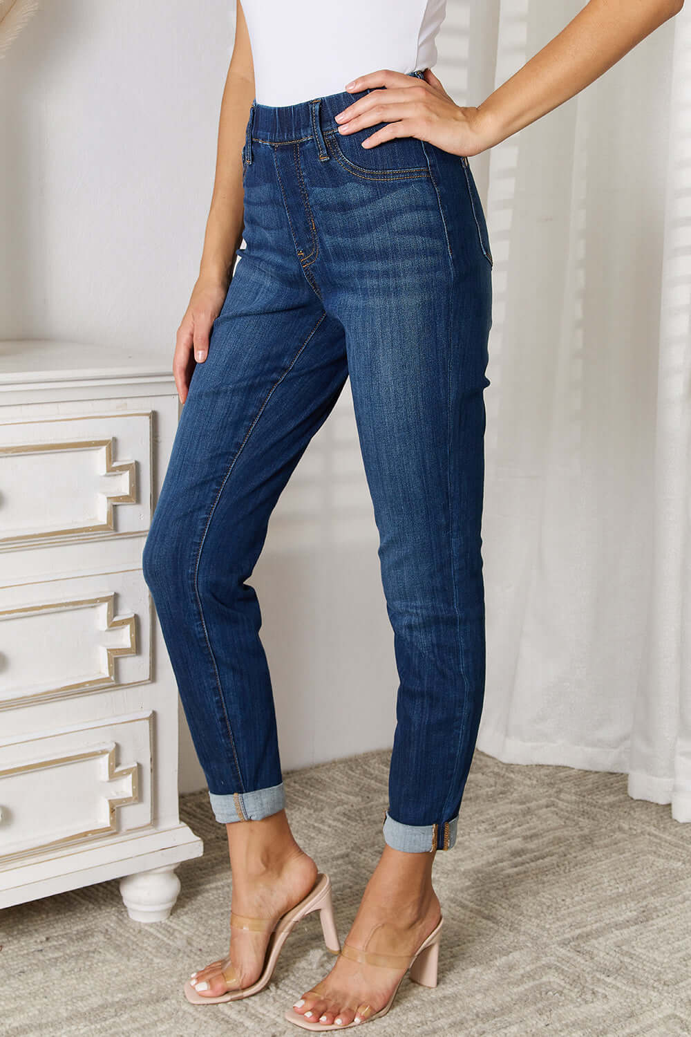 Skinny cropped Judy Blue jeans, styled with a white top and heels, showcasing trendy and stylish fit suitable for versatile outfits