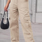 Woman wearing Baeful Long Straight Leg Jeans with pockets and holding a black handbag, showcasing chic and casual fashion style.