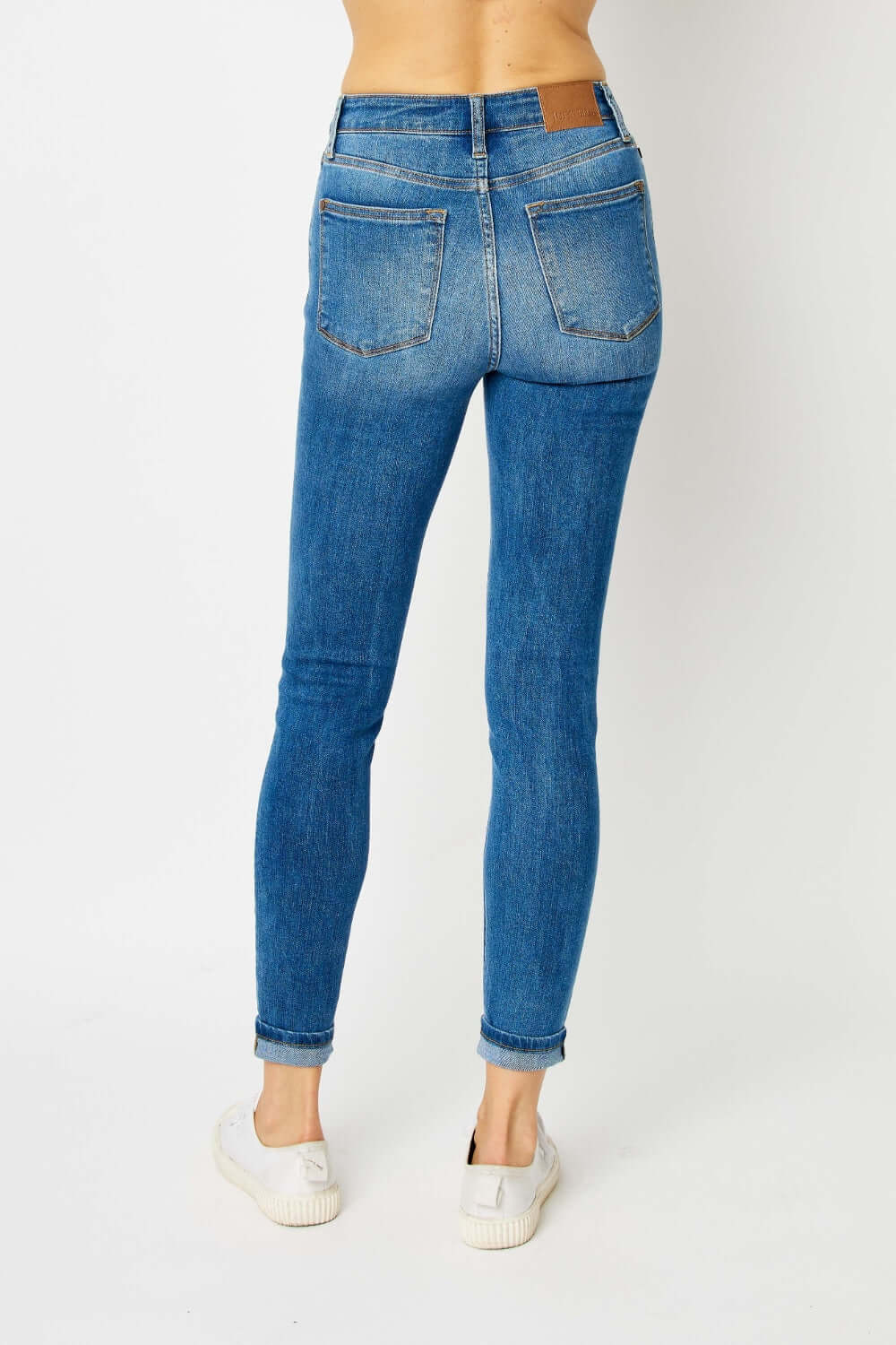 Back view of cuffed hem low waist skinny jeans by Judy Blue, featuring a flattering slim fit and modern flair