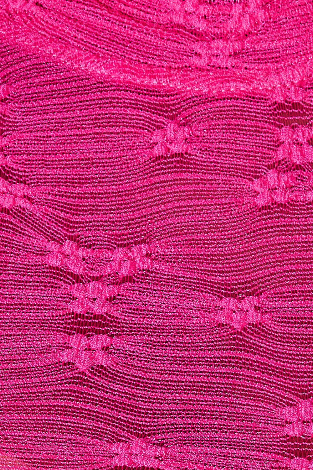 Close-up of pink semi-sheer fabric with a textured pattern and floral accents