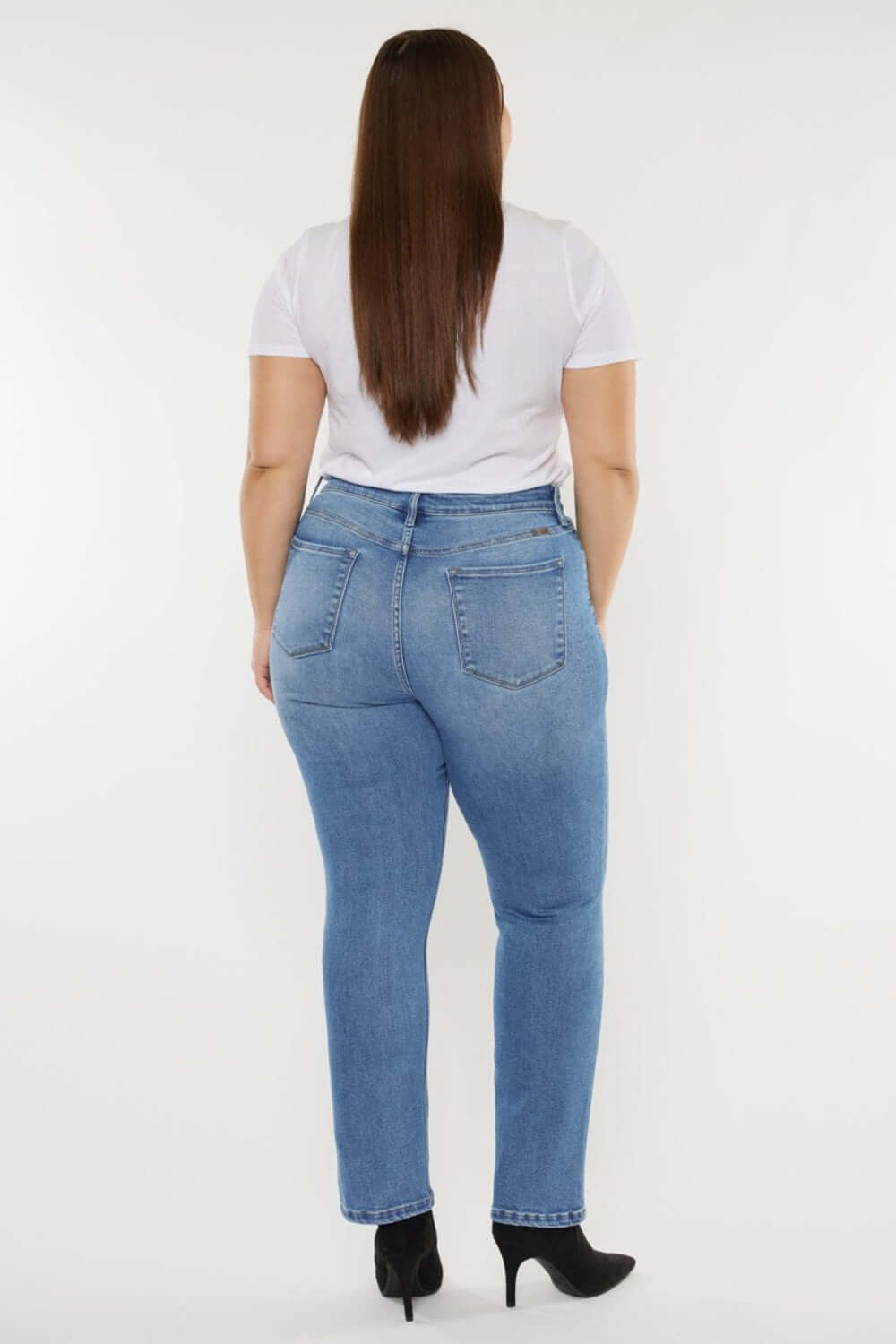 Woman wearing Cat's Whiskers High Waist Jeans with retro detailing, showcasing a flattering back view and stylish fit.