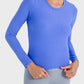 Model wearing a blue Millennia Round Neck Long Sleeve Sports Top, showcasing its comfort and stylish fit for workouts.