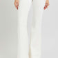 Woman wearing RISEN full size high rise flare jeans with front patch pockets in white, showcasing stylish and trendy look.