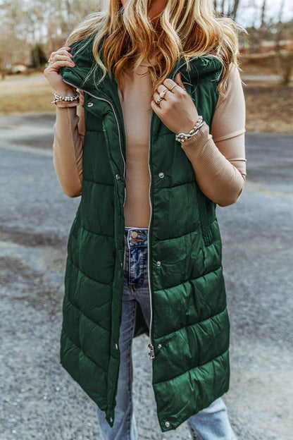 Woman wearing Bella Road Longline Hooded Sleeveless Puffer Vest in green, perfect for stylish outdoor comfort and versatility.