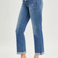 Woman wearing Button-Fly Cropped Bootcut Jeans from Risen Jeans, showcasing retro button fly closure and stylish cropped length.