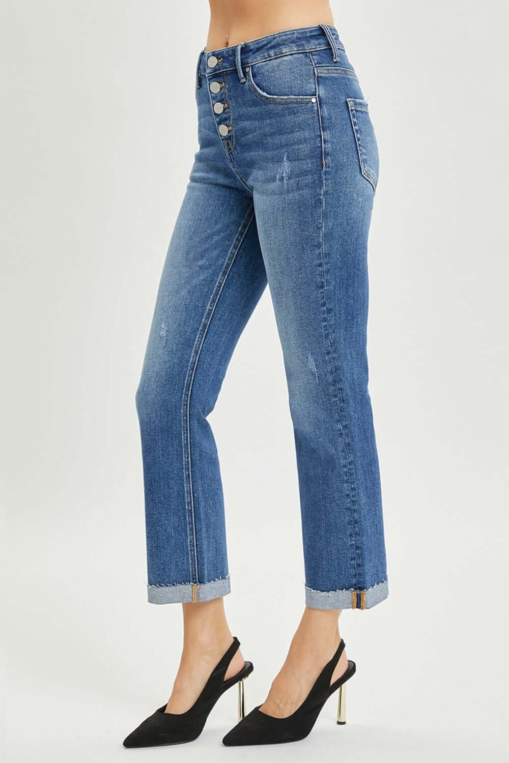 Woman wearing Button-Fly Cropped Bootcut Jeans from Risen Jeans, showcasing retro button fly closure and stylish cropped length.