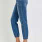 Woman wearing RISEN full size high rise ankle jogger jeans with elastic cuffs, styled with white heels for a sleek and trendy look.