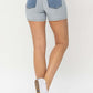 Back view of woman wearing Judy Blue Jeans color block denim shorts, showcasing stylish and bold design perfect for summer wear.