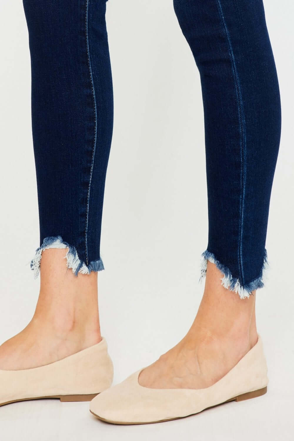 High Rise Frayed Ankle Skinny Jeans with distressed hem paired with beige flats