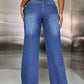 Woman wearing wide leg jeans with pockets, back view showing pocket design and fashion-forward style in blue denim.