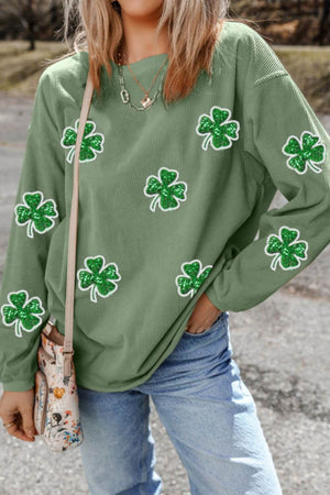 Model wearing a Bella Road long sleeve sweatshirt with green sequin clovers, perfect for St. Patrick's Day style.