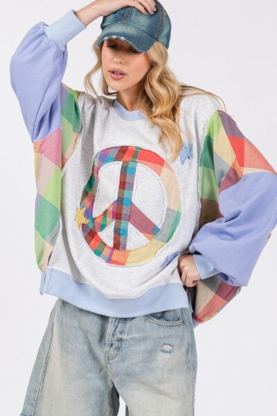 Colorful contrast peace patch sweatshirt with dropped shoulders, perfect for casual style and comfort.