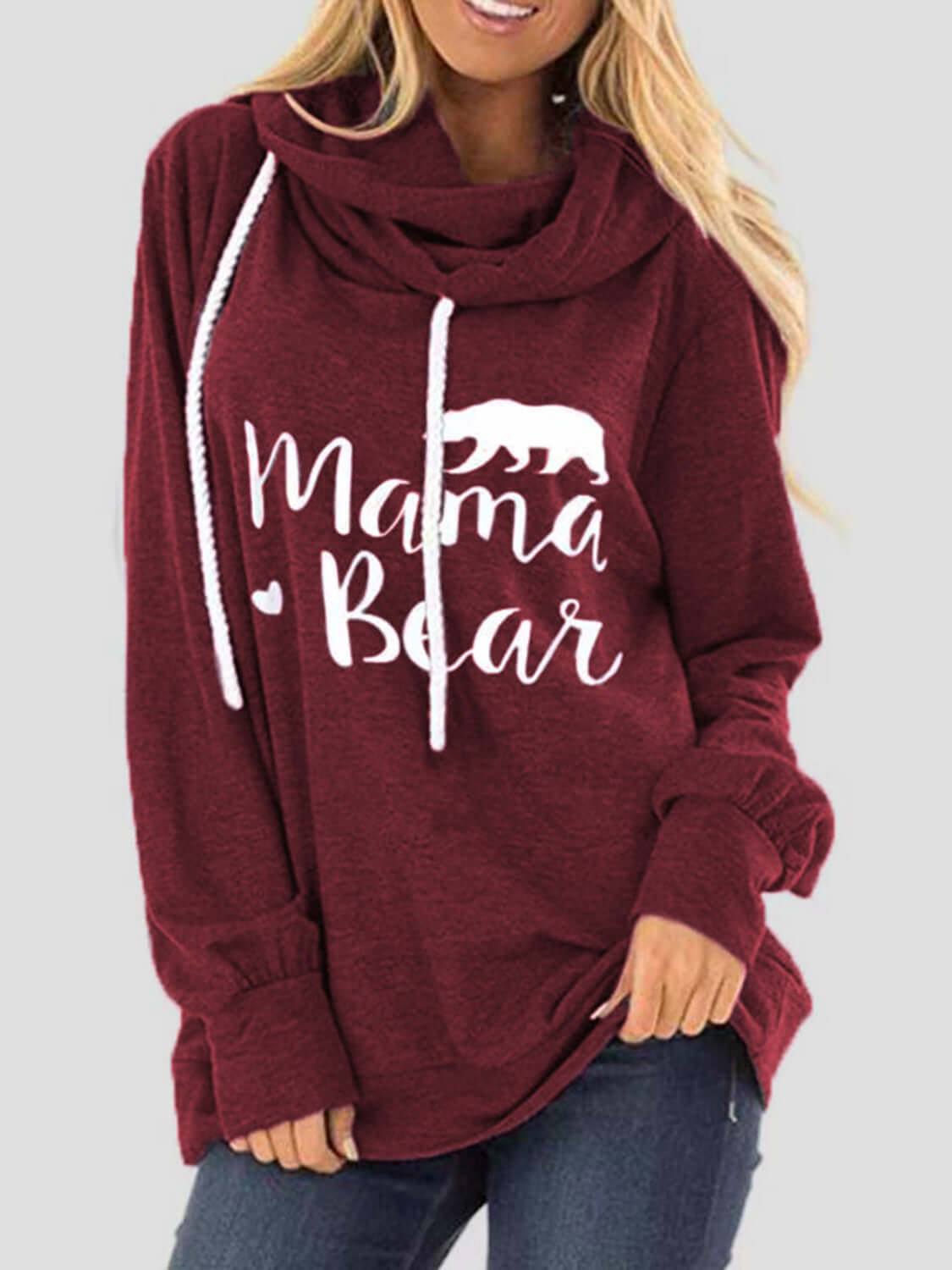 Woman wearing a maroon drawstring hoodie with "Mama Bear" graphic and bear silhouette.