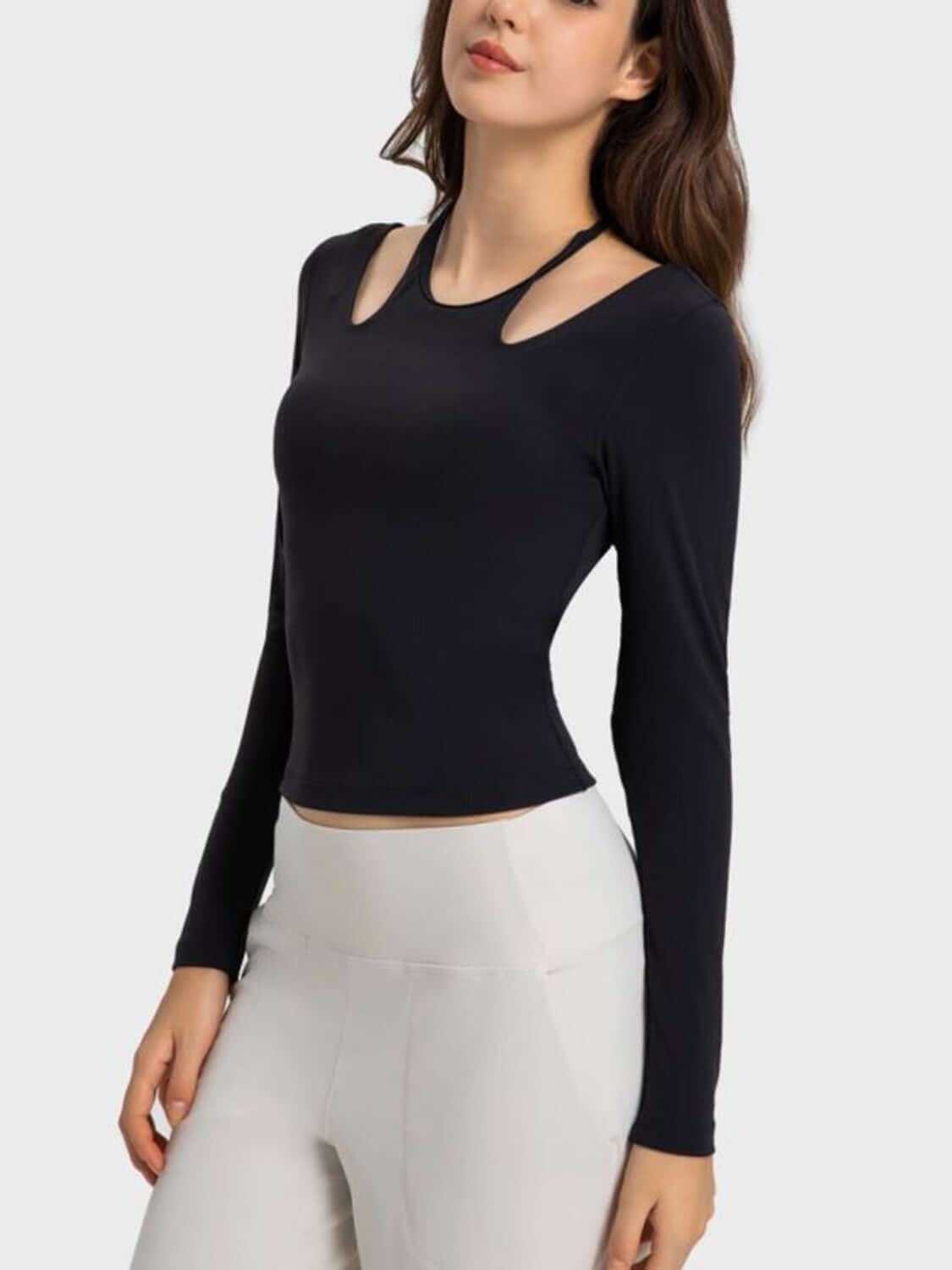 Millennia Halter Neck Long Sleeve Sporty Top in black, showcasing stylish cutouts and a fitted design for workouts.