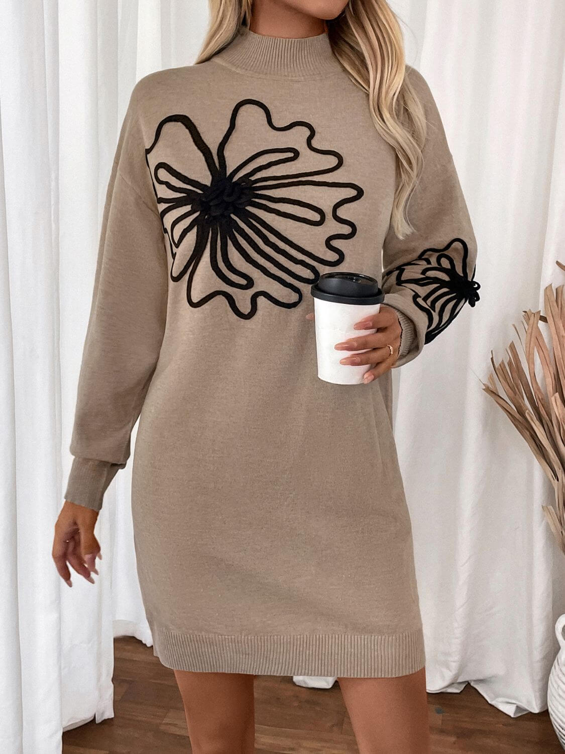 Woman wearing Perfee Flower Mock Neck Long Sleeve Sweater Dress holding a coffee cup, showcasing cozy and stylish fashion for any occasion