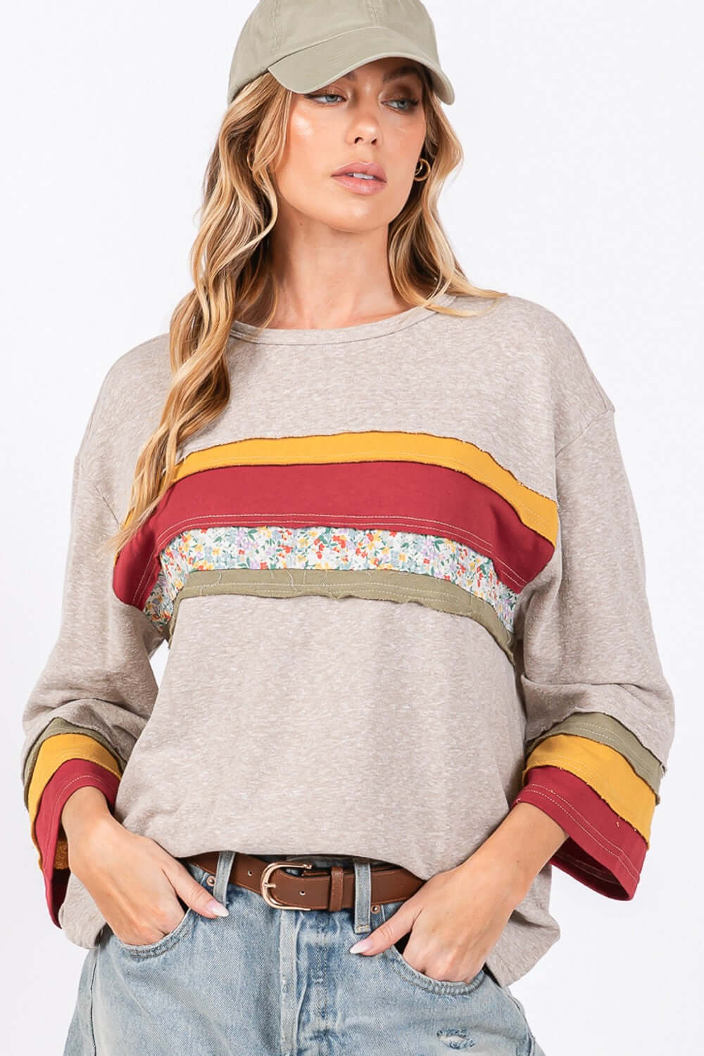 Woman wearing French Terry Color Block T-Shirt with 3/4 sleeves, multi-color detailing, and floral contrast front, perfect for a trendy look.