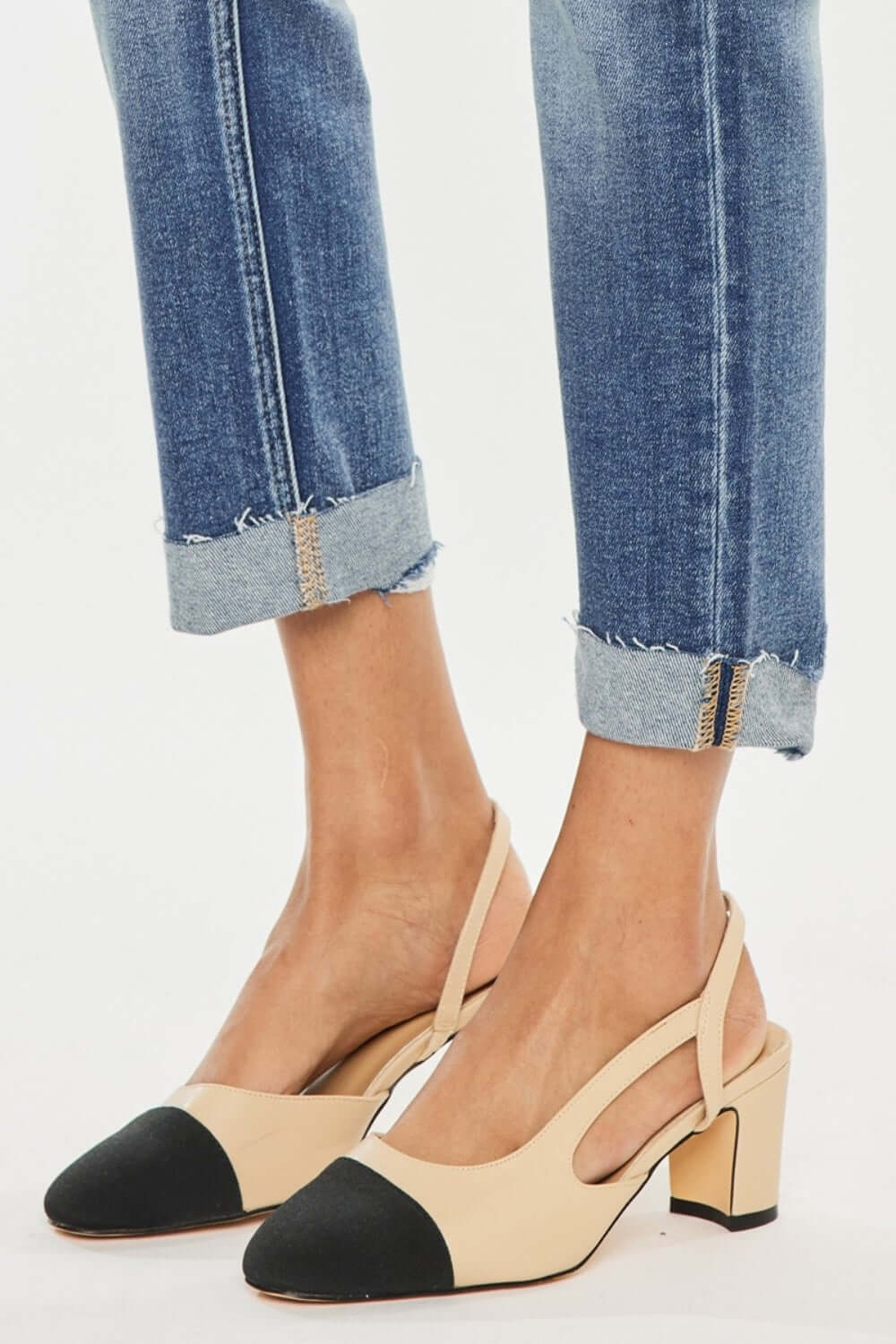 High Rise Cuffed Straight Jeans with beige and black block heels close-up