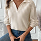 Woman wearing Ribbed Johnny Collar Long Sleeve T-Shirt in white, paired with jeans, holding a coffee cup.