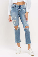 Woman wearing Lovervet Full Size High Rise Slim Straight Jeans with distressed details and a casual white top.