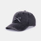 Bow embroidered washed cotton cap in black with delicate bow design, stylish and comfortable casual accessory for everyday wear.