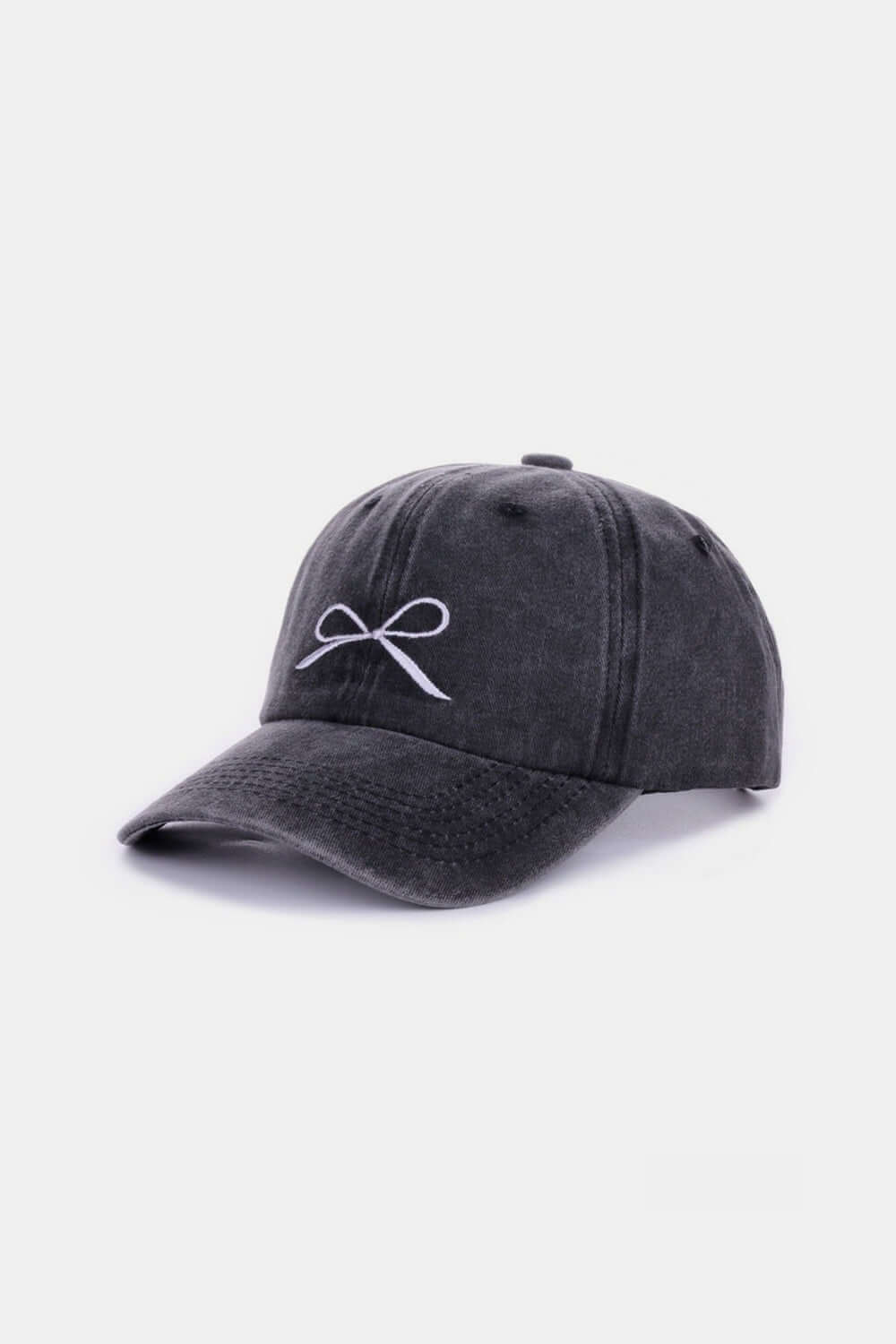 Bow embroidered washed cotton cap in black with delicate bow design, stylish and comfortable casual accessory for everyday wear.