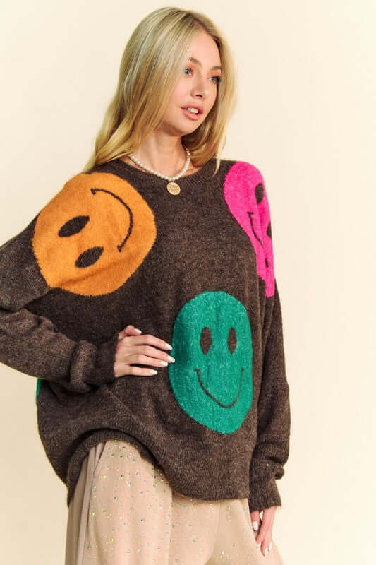 Fun oversized sweater with colorful smiley faces, perfect for a cozy and stylish casual look.